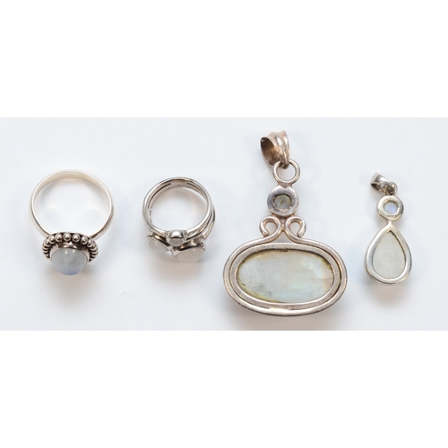 205 - Two silver moonstone rings and two silver moonstone drop pendants, largest 50 x 33mm, 34gm.