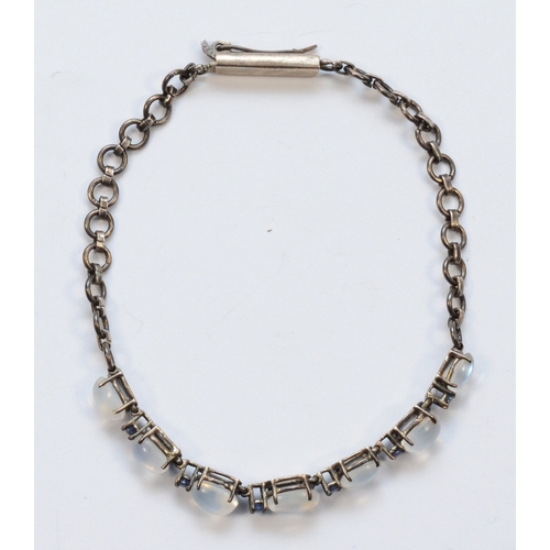 206 - A silver moonstone and sapphire bracelet, unmarked, 20cm, 6gm.