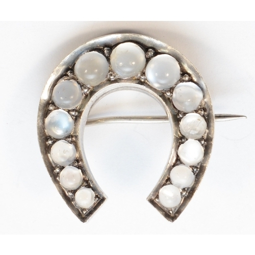 209 - A Victorian silver moonstone horseshoe brooch, unmarked, 28 x 30mm, 10gm.