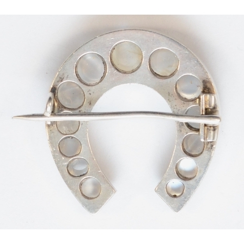 209 - A Victorian silver moonstone horseshoe brooch, unmarked, 28 x 30mm, 10gm.