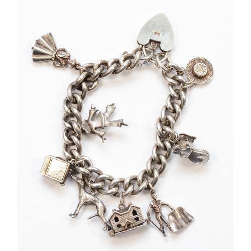 210 - A silver heart padlock clasp charm bracelet, with charms to include a gray hound, 65gm.