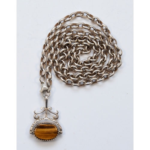 221 - A vintage silver tigers eye and onyx swivel fob, on a silver chain, 35 x 25mm, 46gm.