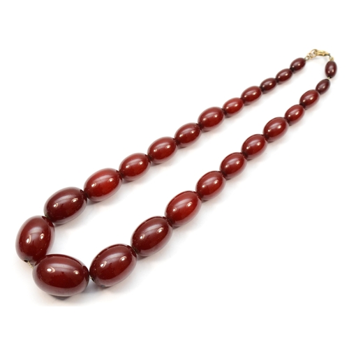 225 - A cherry amber Bakelite graduated beaded necklace, 10 - 25mm beads, 44cm.