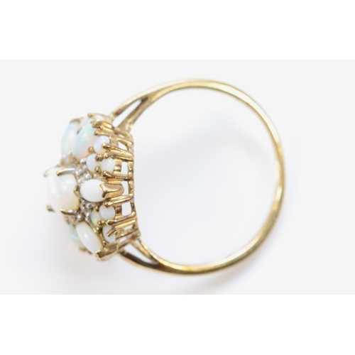 239 - A 9ct gold opal floral cluster ring, flashes of red and green, T, 3.7gm.