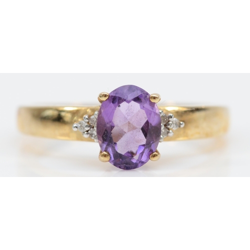 243 - A 9ct gold oval cut amethyst and eight cut diamond dress ring, Q, 2.6gm.