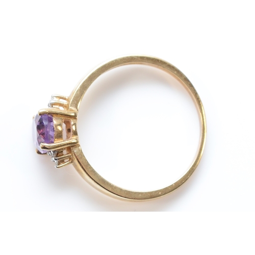 243 - A 9ct gold oval cut amethyst and eight cut diamond dress ring, Q, 2.6gm.