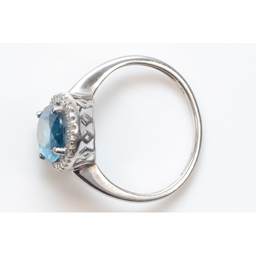 312 - A 9ct white gold blue topaz and eight cut diamond dress ring, N, 2.7gm.