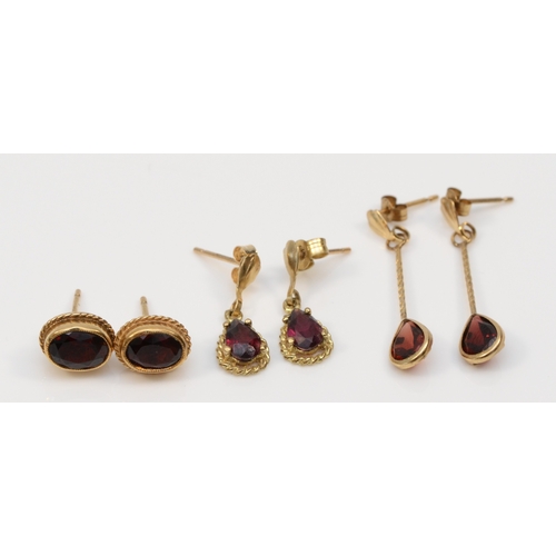 331 - A pair of 9ct gold garnet stud earrings, 8 x 6mm, together with two other pairs of gold garnet drop ... 