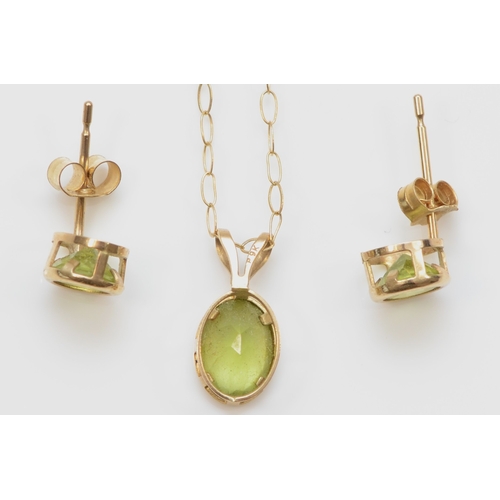 369 - A 9k gold peridot pendant, on a 375 gold chain, 12mm, together with a pair of unmarked gold peridot ... 