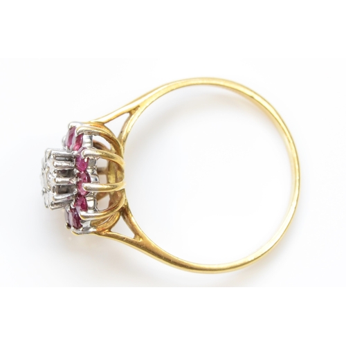 376 - An 18ct gold ruby and brilliant cut diamond cluster ring, R-S, 3.5gm.