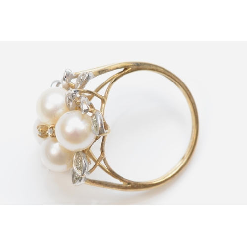 382 - A 9ct gold cultured pearl and brilliant cut diamond floral dress ring, O, 4.7gm.