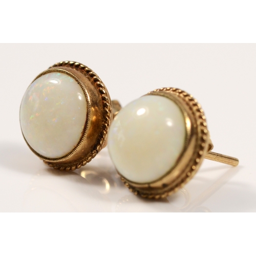 384 - A pair of 9ct gold opal stud earrings, flashes of red, green and blue, 12mm, 3.9gm.