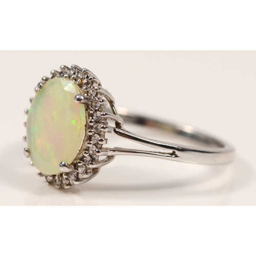 387 - A 9ct white gold synthetic opal and white stone dress ring, O, 2.4gm.