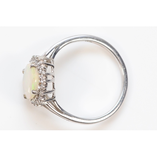 387 - A 9ct white gold synthetic opal and white stone dress ring, O, 2.4gm.