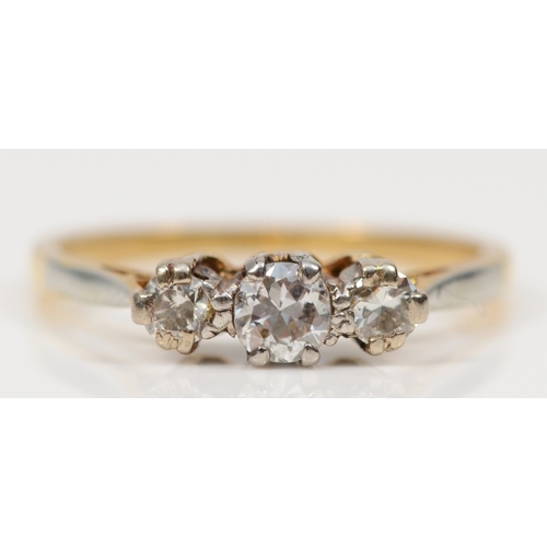 404 - A gold three stone brilliant cut diamond dress ring, unmarked, M, 2.2gm.