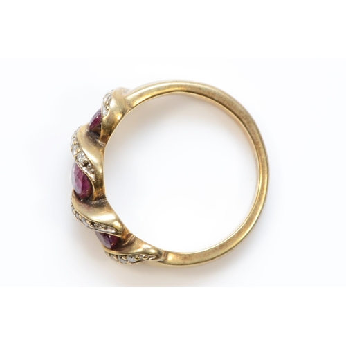 414 - A 9ct gold ruby and brilliant cut diamond dress ring, J, 3gm.