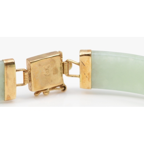 443 - A 9ct gold jadeite paneled bracelet, 19.5cm, 10.9gm.