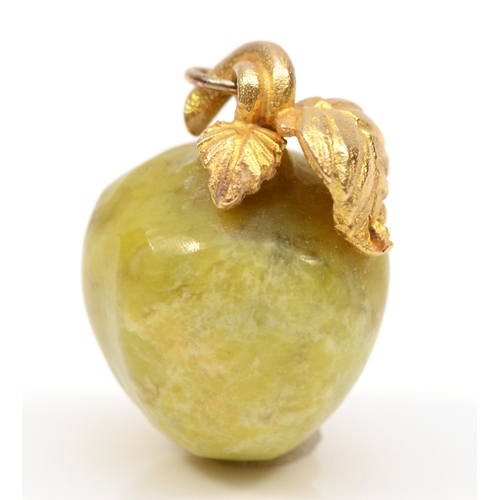 453 - A hard stone apple charm, with gold mounted leaf and stork decoration, 19mm,