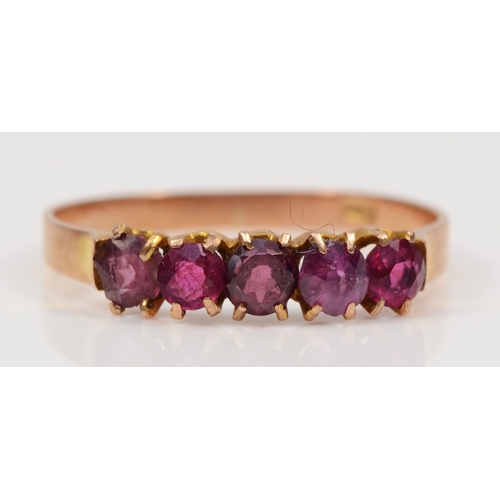 477 - A 9ct rose gold five stone garnet dress ring, Q-R, 1.4gm.