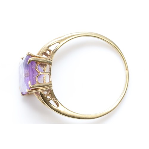 495 - A 9ct gold single stone amethyst cocktail dress ring, T, 2.9gm.