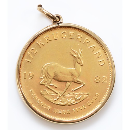 501 - A 1982 1/2 gold Krugerrand, in a gold mount, 18.3gm.