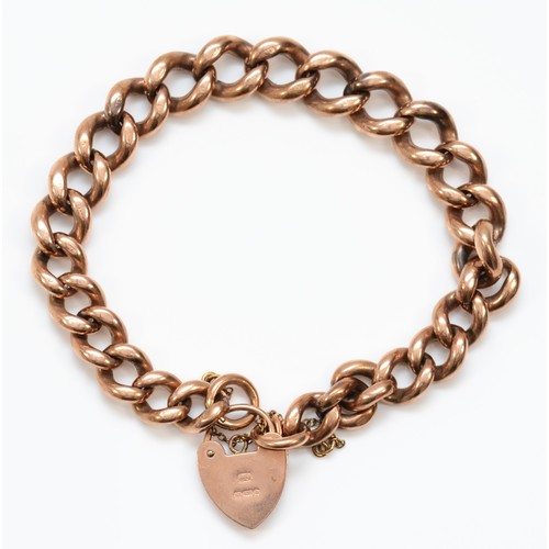 502 - A 9ct rose gold curb link heart padlock clasped bracelet, 47gm.