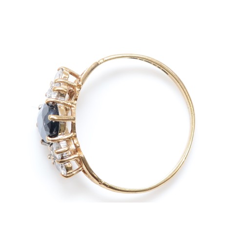 511 - A 9ct gold sapphire and white stone dress ring, K, 1.3gm.