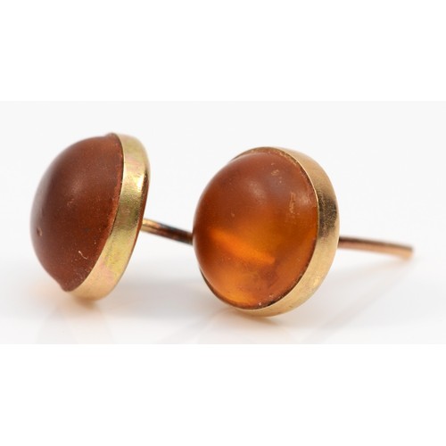 524 - A pair of gold Baltic amber stud earrings, 9mm, 1.1gm, lacking backs.