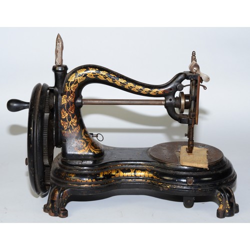 A late 19th century Jones portable hand sewing machine, black painted cast metal having gold vine leaf decoration to the swan neck, the cloth plate bearing the company's stamped trade mark, L39, H25cm.
