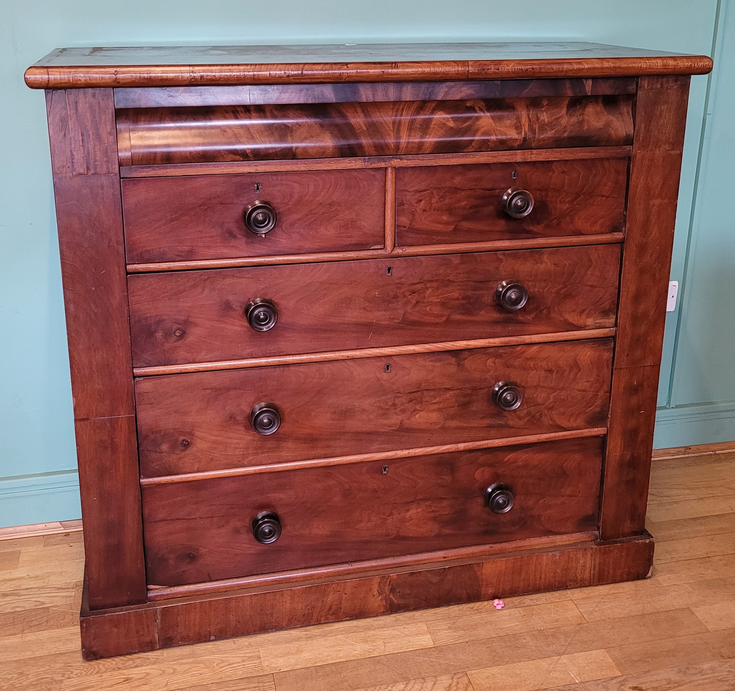 A Victorian mahogany chest of drawers, shaped upper frieze drawer, two ...
