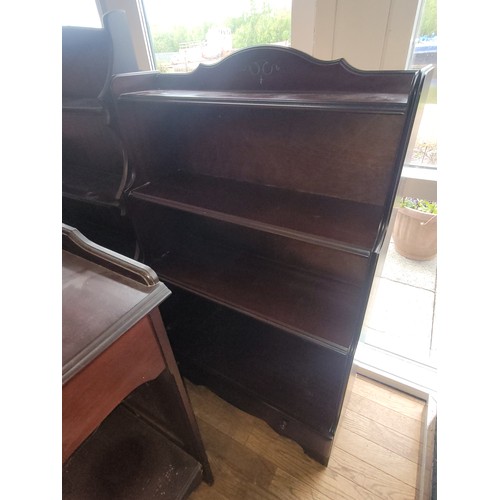 99 - An Ercol 'waterfall' four height freestanding bookshelf unit, H127, W85, D33cm, together with a simi... 