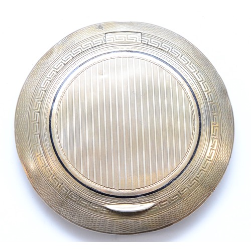 63 - An Art Deco silver and black enamel compact, London import 1922, lacking interior, diameter 8.5cm, 7... 