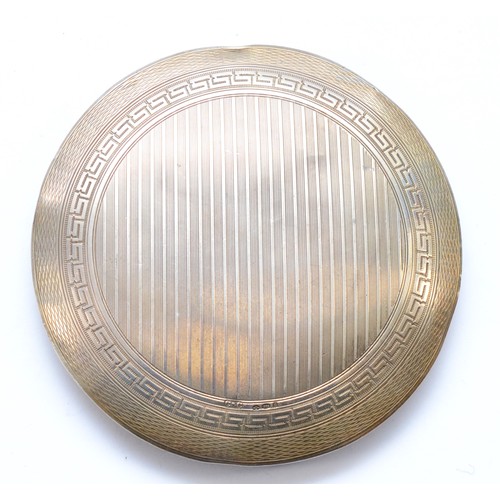 63 - An Art Deco silver and black enamel compact, London import 1922, lacking interior, diameter 8.5cm, 7... 