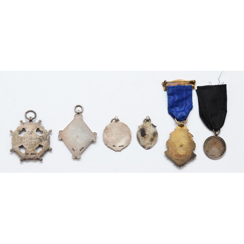 74 - Five silver watch fobs and a silver gilt and enamel Rotary International badge, 76gms