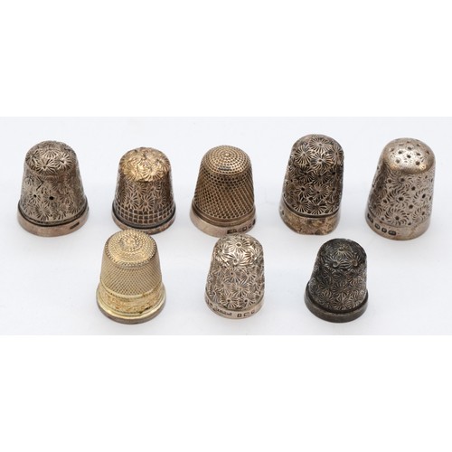 87 - Six silver thimbles and a Sterling Silver example, 30gm