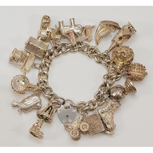 189 - A heavy silver charm bracelet, 107gm