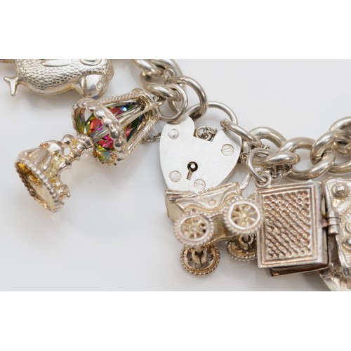 189 - A heavy silver charm bracelet, 107gm