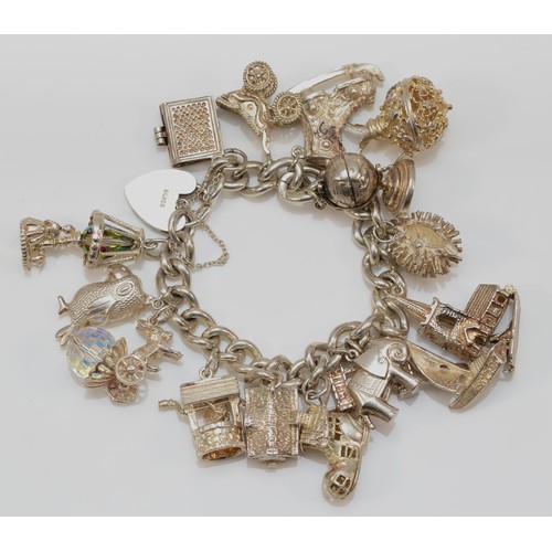 189 - A heavy silver charm bracelet, 107gm