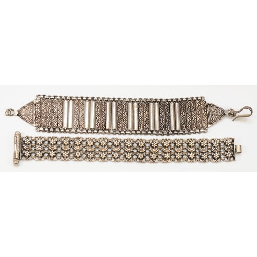 209 - An unmarked silver cluster bracelet, slide clasp, 18cm and another panel link bracelet, 95gm