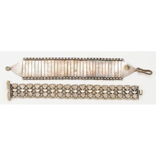 209 - An unmarked silver cluster bracelet, slide clasp, 18cm and another panel link bracelet, 95gm