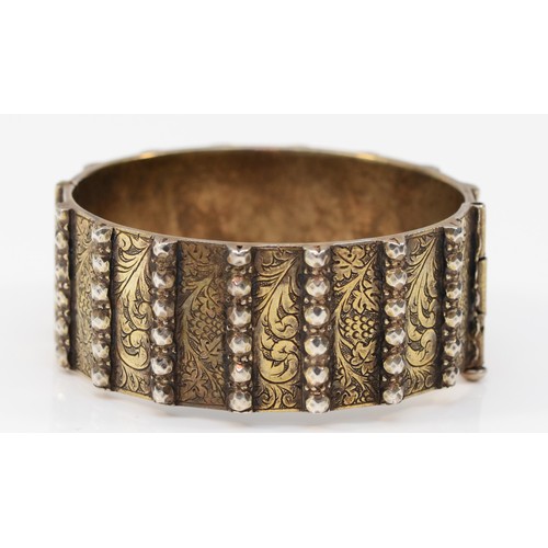 219 - A heavy unmarked silver gilt hinged bangle, with slide clasp, 58 x 53mm, 90gm