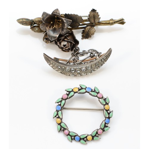 222 - An unmarked silver and enamel wreath brooch, 33mm, a silver gilt rose brooch and a paste set crescen... 