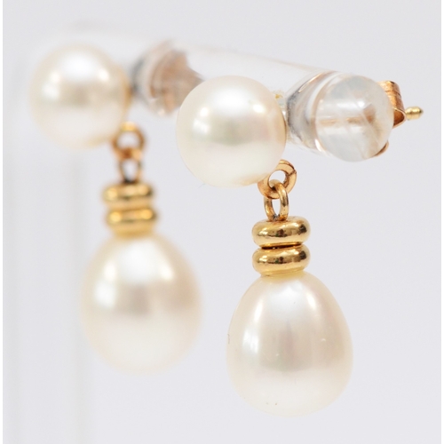 238 - A 14K gold mounted pair of cultured pearl ear drops, 19mm