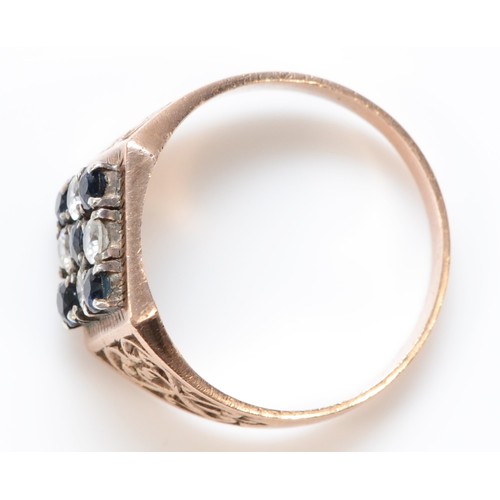 431 - An unmarked 9ct rose gold, sapphire and white stone checkerboard panel ring, S, 4.5gm.