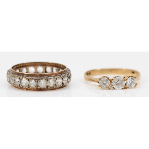 446 - A 9ct gold and CZ three stone ring, M, 1.9gm and a 9ct and silver white stone full eternity ring, N.