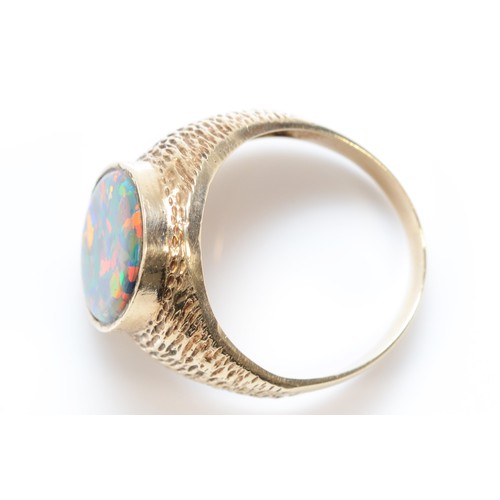 451 - An unmarked 9ct gold and black opal doublet/triplet gentleman's signet ring, stone 18 x 14mm, textur... 