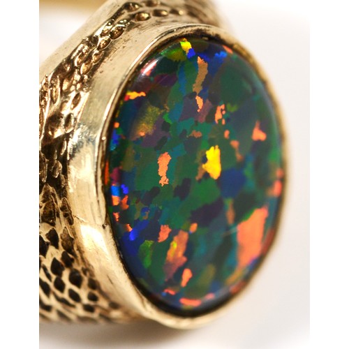 451 - An unmarked 9ct gold and black opal doublet/triplet gentleman's signet ring, stone 18 x 14mm, textur... 