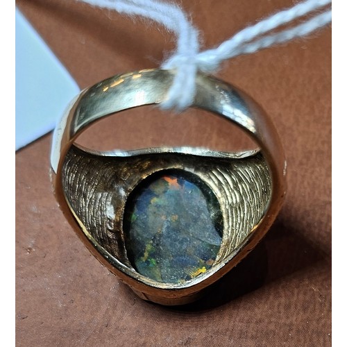 451 - An unmarked 9ct gold and black opal doublet/triplet gentleman's signet ring, stone 18 x 14mm, textur... 