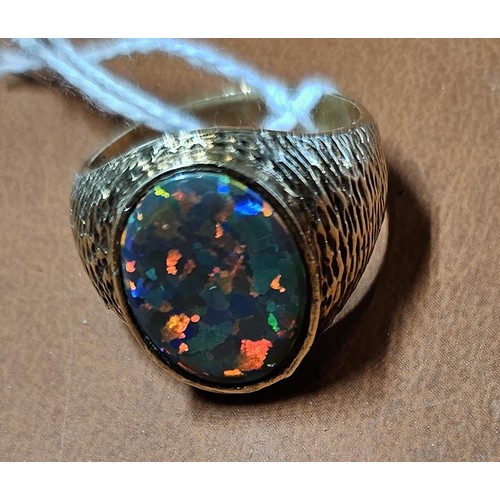 451 - An unmarked 9ct gold and black opal doublet/triplet gentleman's signet ring, stone 18 x 14mm, textur... 