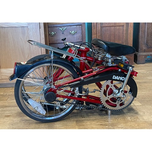 36 - A Dahon folding bicycle, metallic red with carry case.